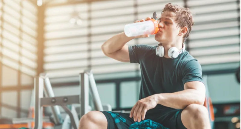 man drinking pre-workout