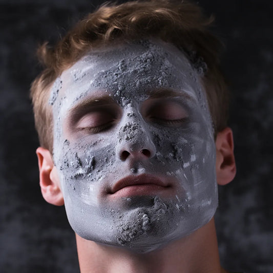 man with a charcoal clay mask