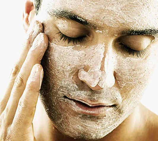 man exfoliating skin with body scrub