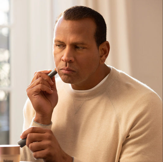 man applying makeup to his face