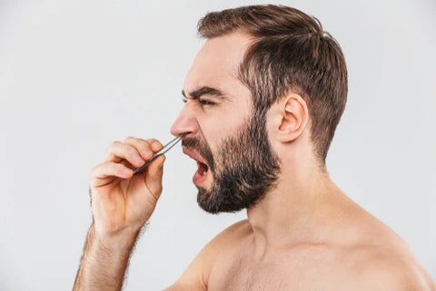 man removing nose hair