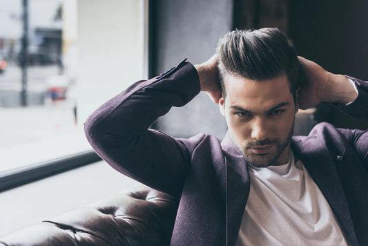 man styling his hair confidently