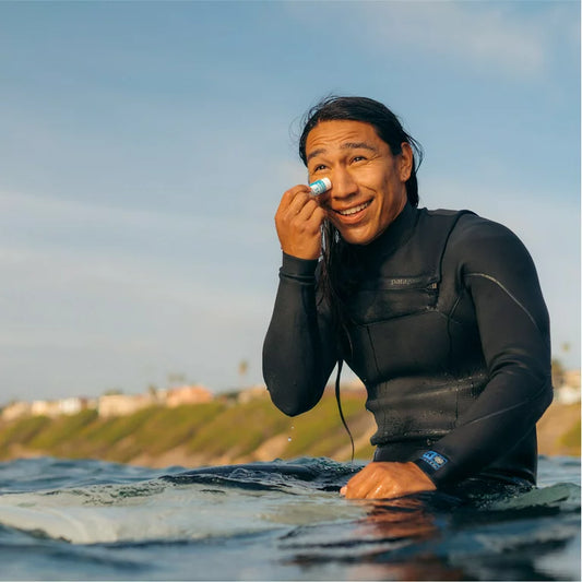 man using sunscreen stick